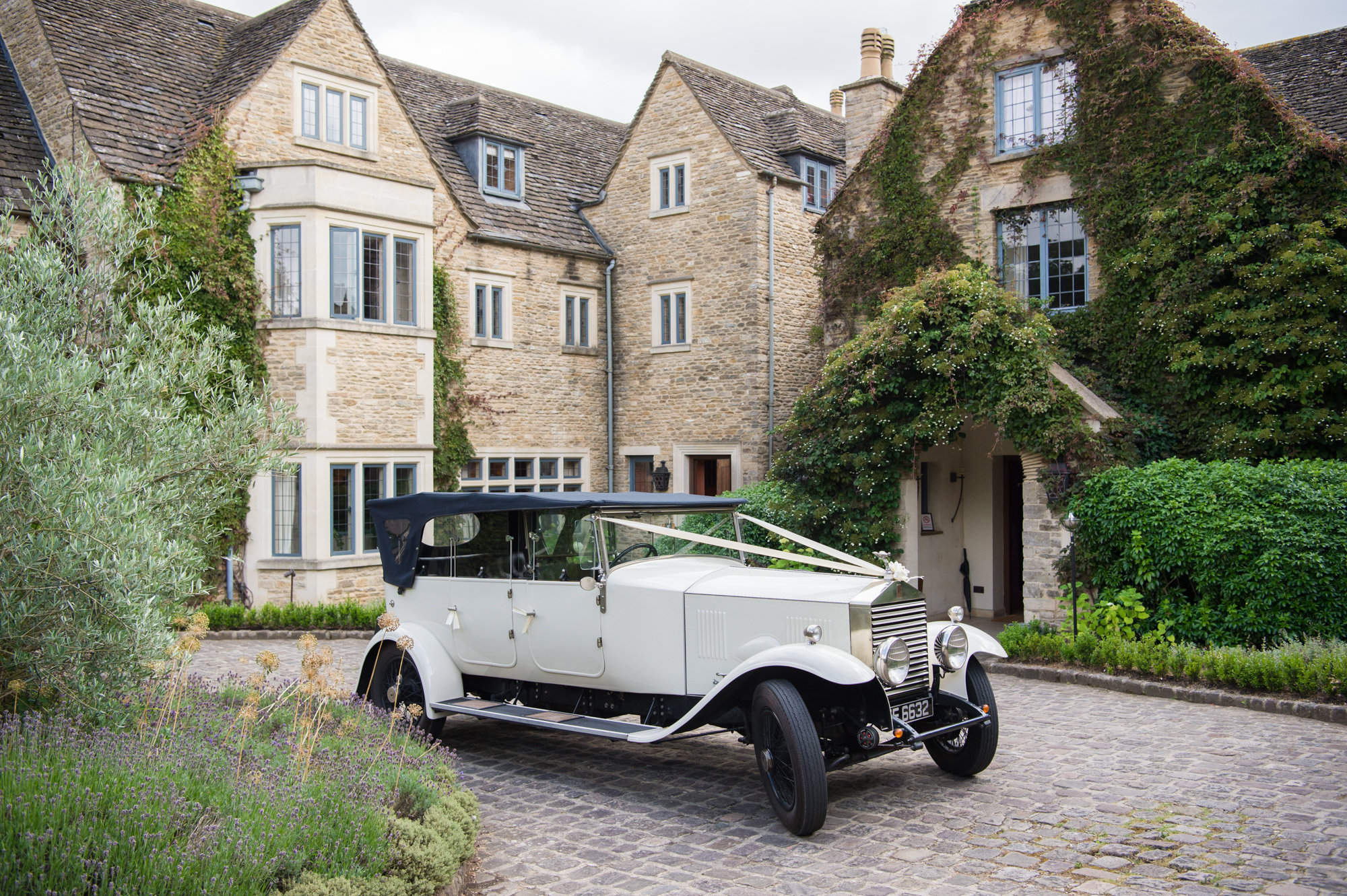 Vintage black and white car with wedding ribbon tied on front